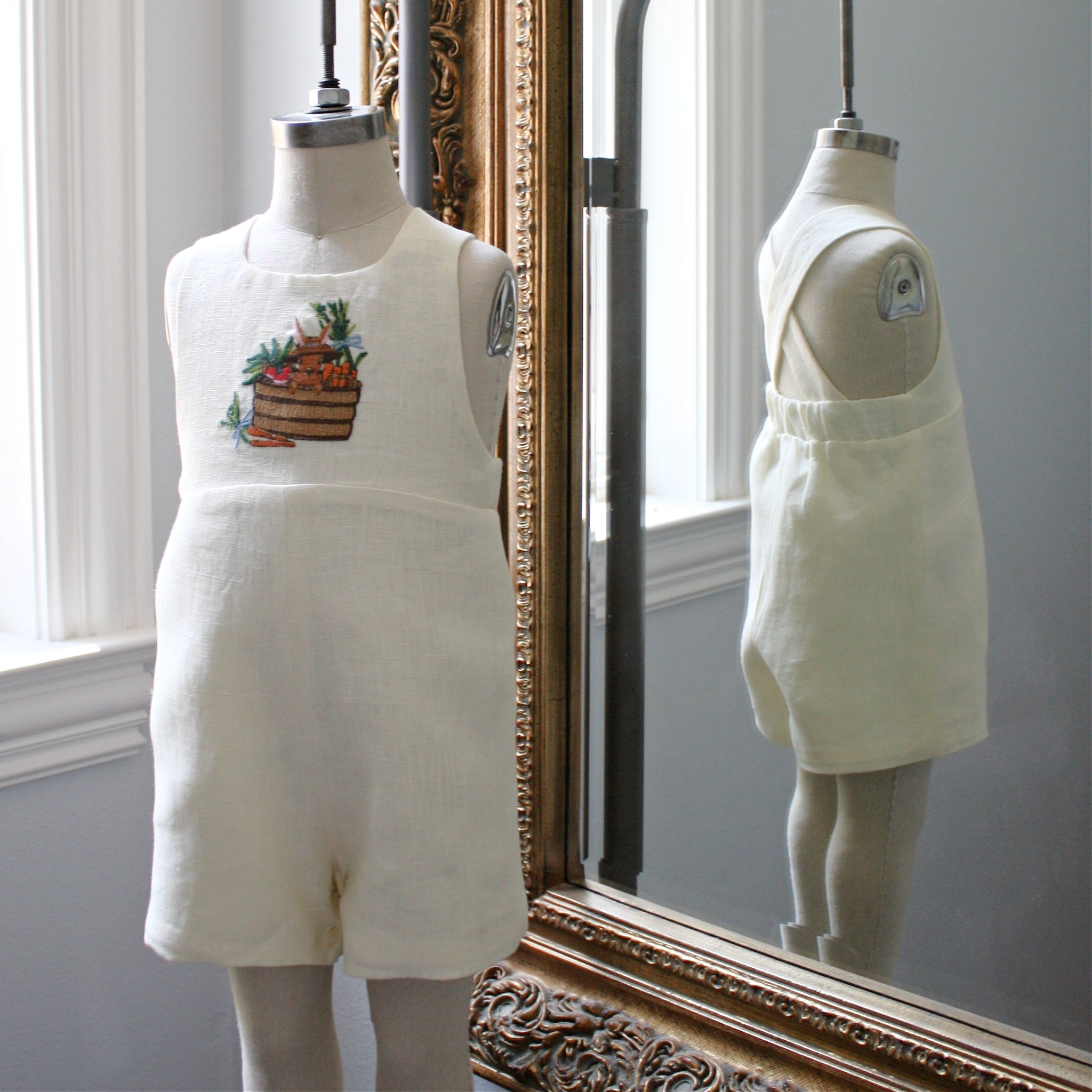 Front and back view of ivory linen romper with embroidered bunny and vegetable basket. Childsware for boys and girls