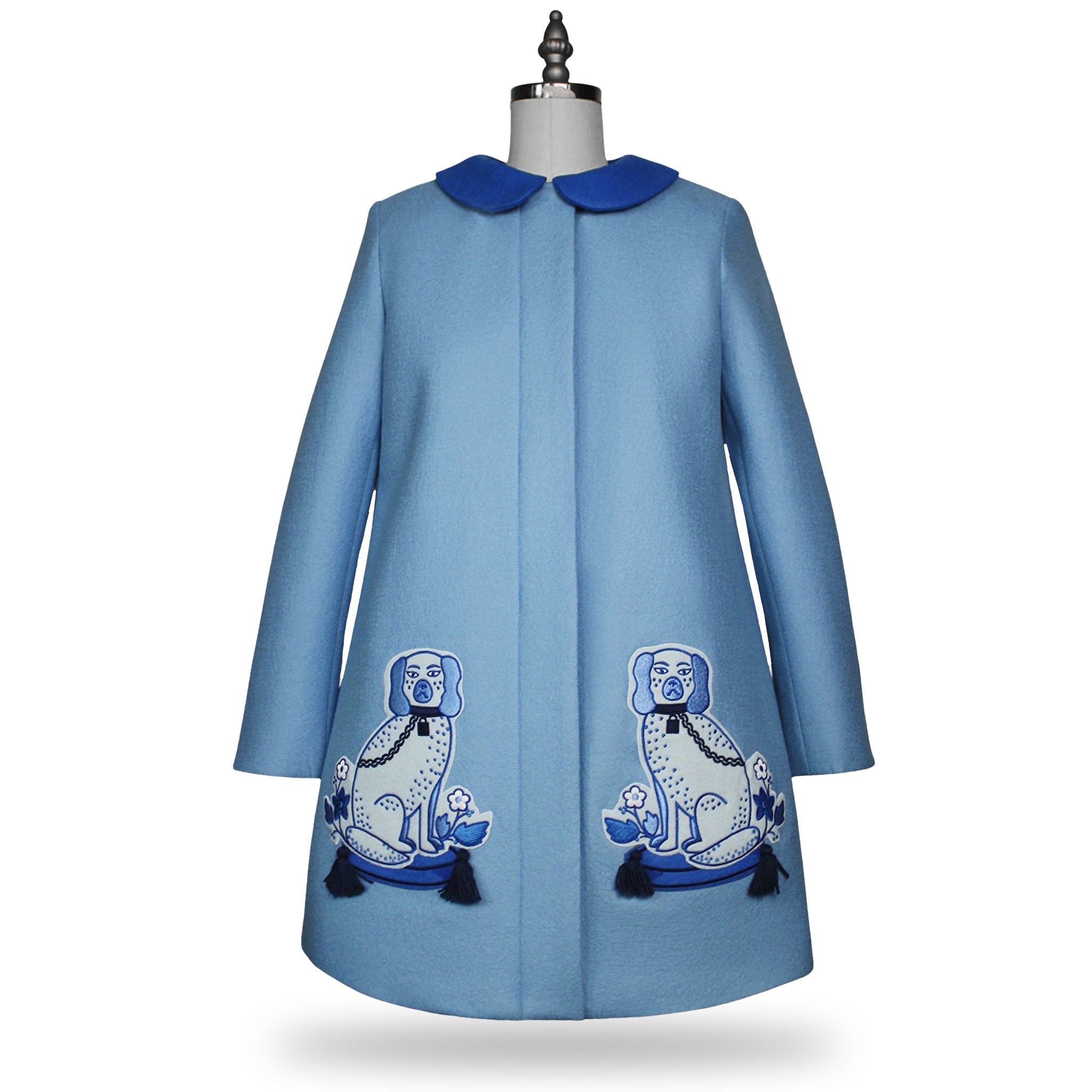 Ladies Aldrich and Madame De Bleu Coat crafted from merino wool in a soft blue hue, featuring intricate embroidered dog designs with tassel details