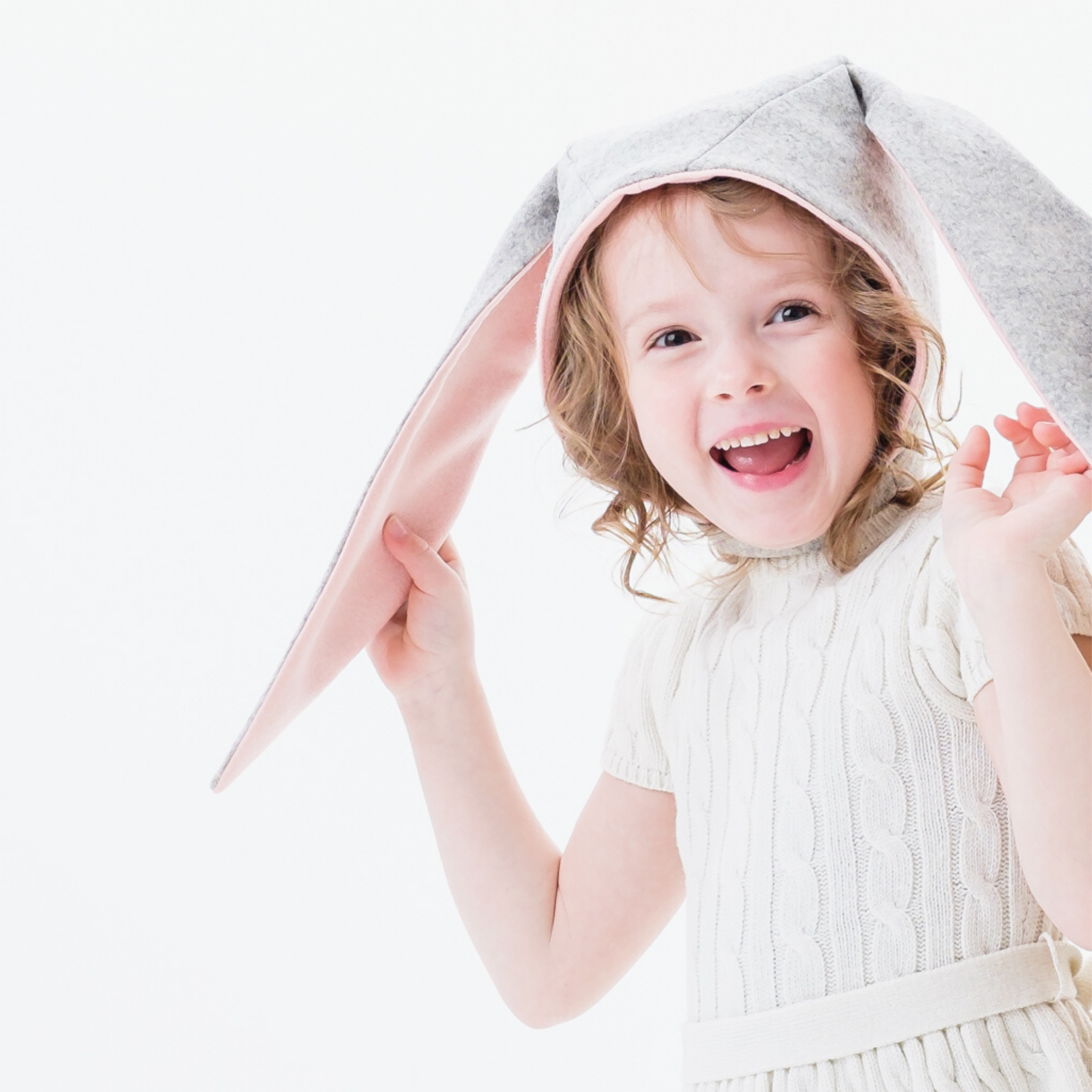 Child wearing Little Goodall Luxe Grey Bunny Hat, featuring floppy bunny ears and a cozy light grey Merino wool design.