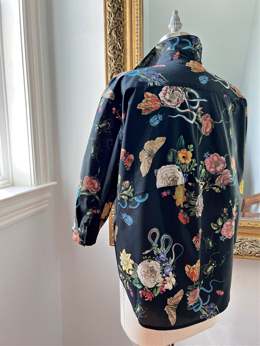 Rear view of the Midnight Grand Botanical Shirt by Little Goodall, featuring a black cotton sateen fabric with an intricate floral and insect print
