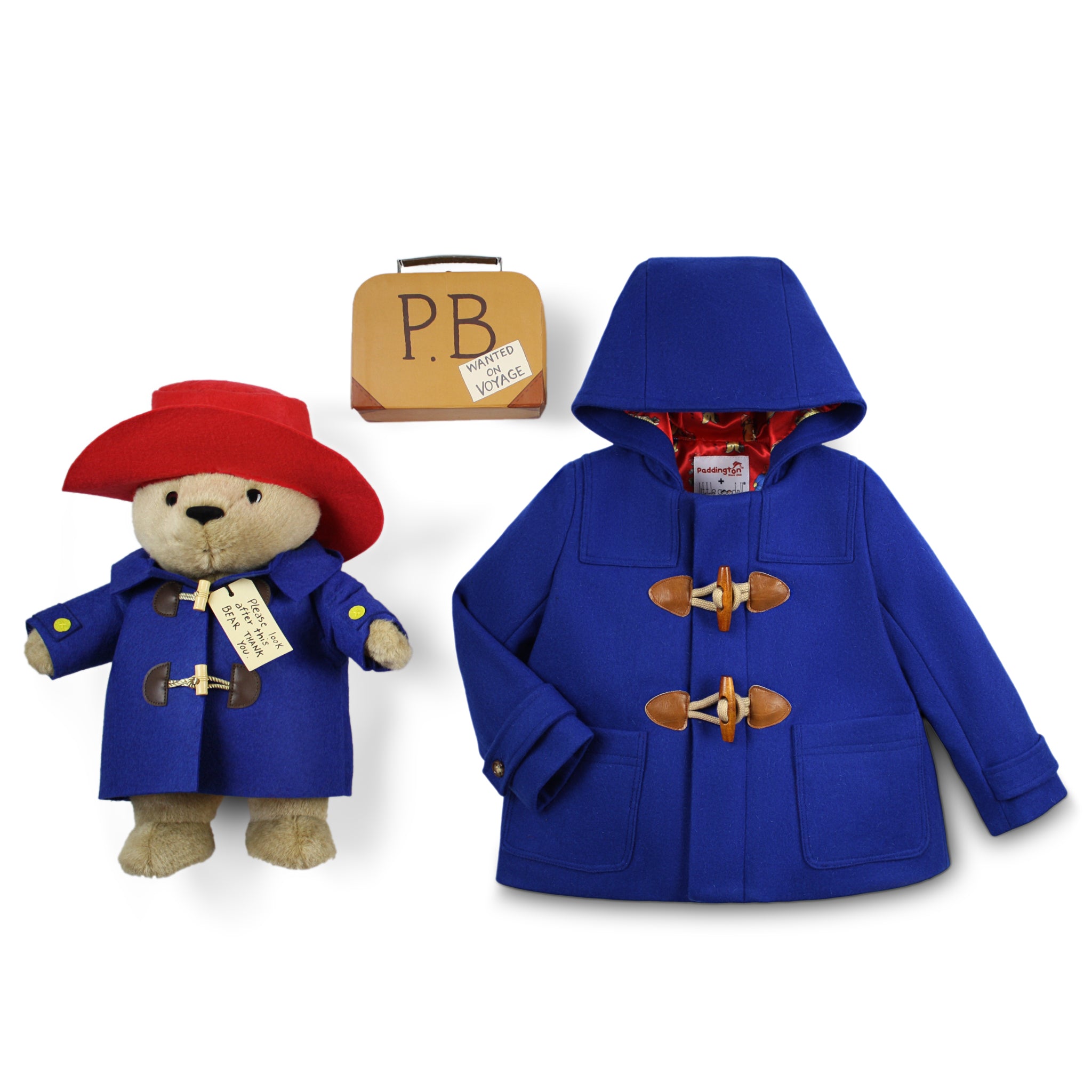 Paddington Bear Gift Set with a royal blue toggle coat, 16" plush bear in a matching coat and red hat, plus a vintage-style suitcase labeled "PB