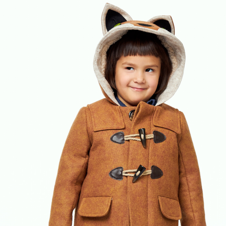 Child wearing a brown wool duffle coat with a fox-themed hood, toggle closures, and front pockets.