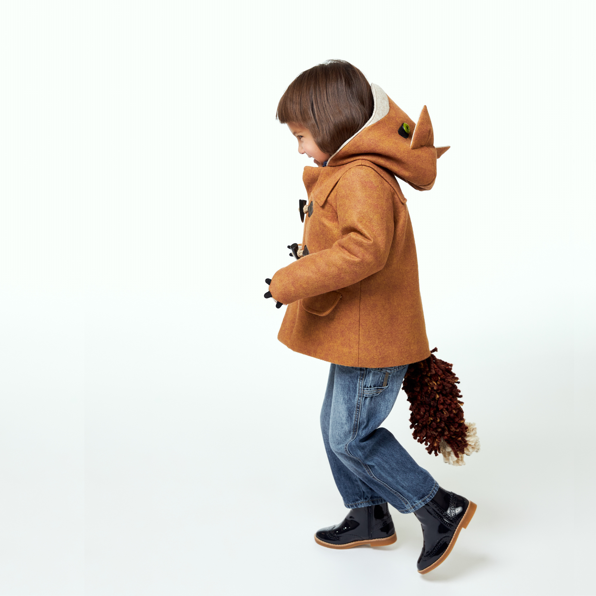 Cozy brown wool coat for toddlers with a fox hood, toggle fastenings, and a playful tail detail