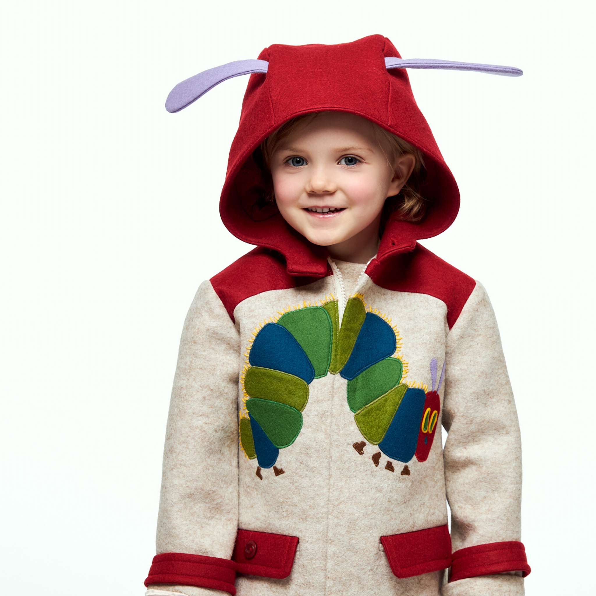 Young girl wearing a warm wool coat with a Hungry Caterpillar appliqué, red hood with purple antennae, and cozy fleece lining for toddlers and kids