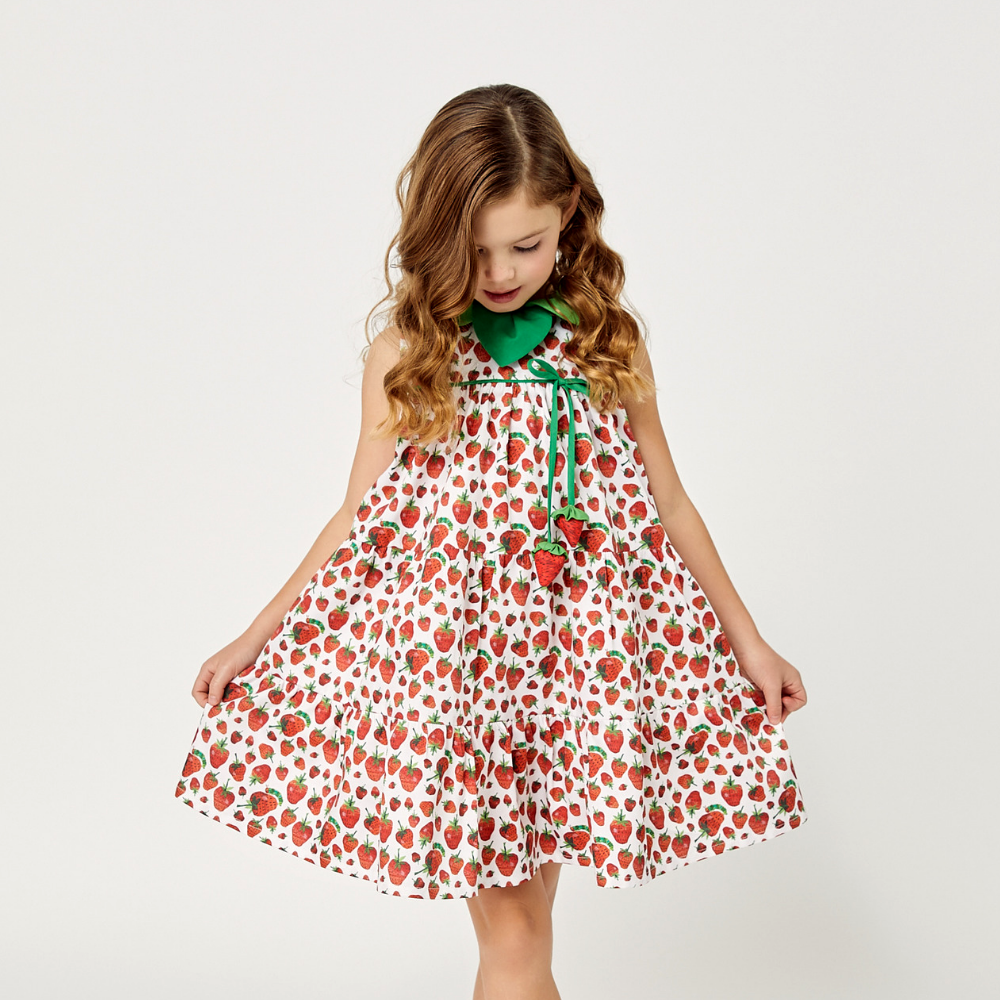  girl in a strawberry print summer dress with playful tiers.
